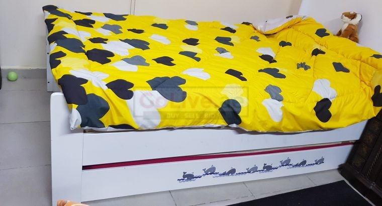 White bed with pullout bed.