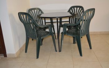 Table (Wrought iron) with glass top and free 4 plastic chairs
