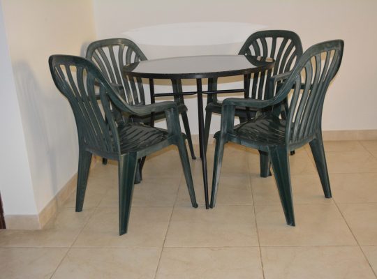 Table (Wrought iron) with glass top and free 4 plastic chairs