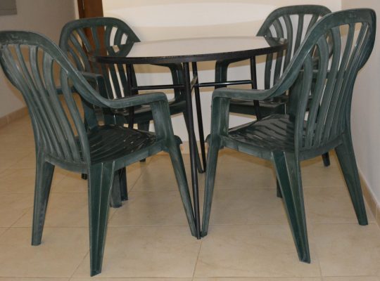 Table (Wrought iron) with glass top and free 4 plastic chairs