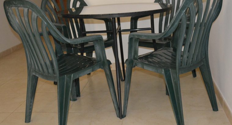 Table (Wrought iron) with glass top and free 4 plastic chairs